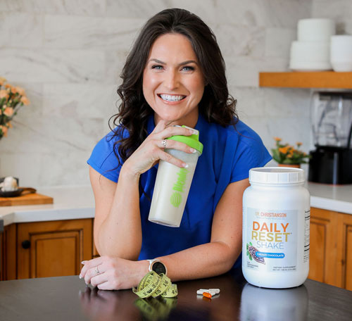 A woman taking a meal replacement.