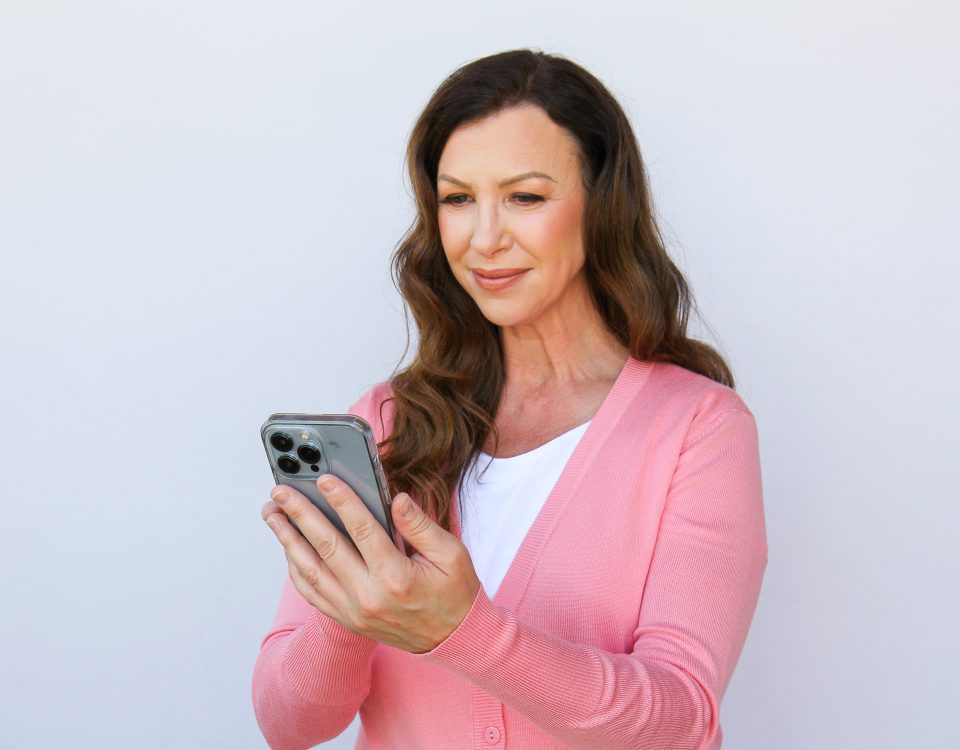 A woman using a cellphone for research.