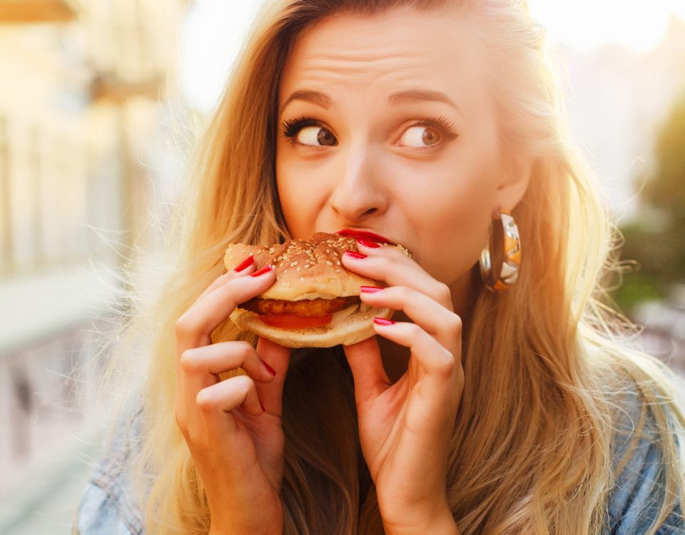Woman bites into a sandwich